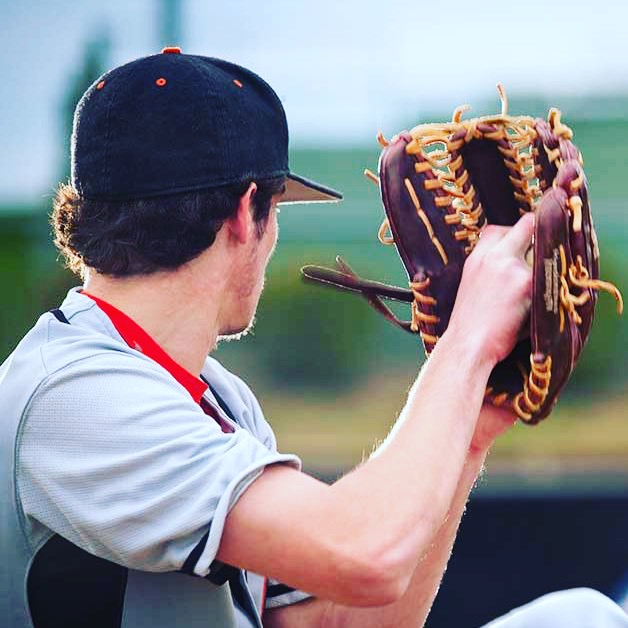 Baseball player with glove raised