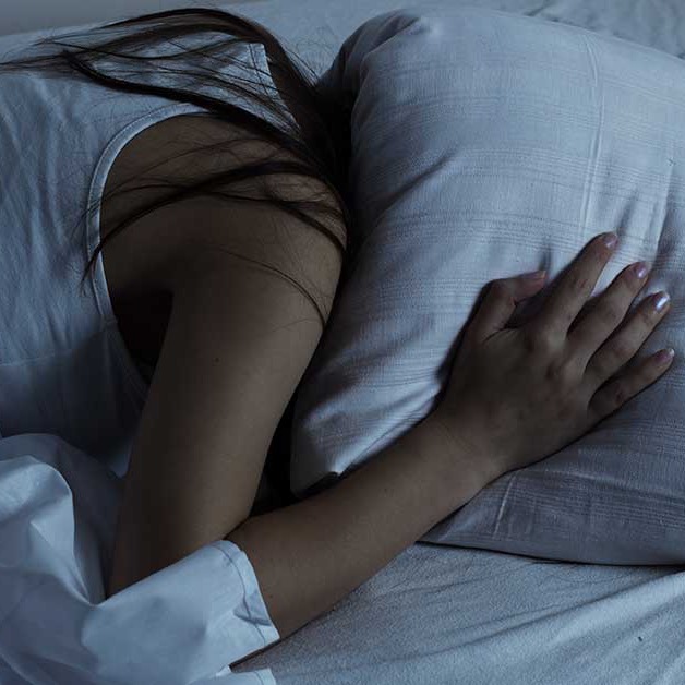 Woman resting face-down on a pillow
